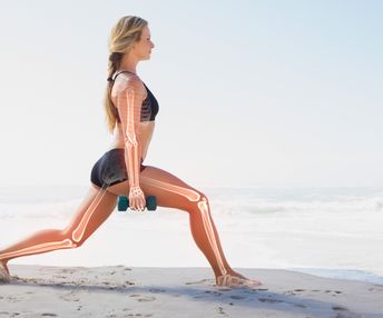 Digital composite of Highlighted bones of exercising woman